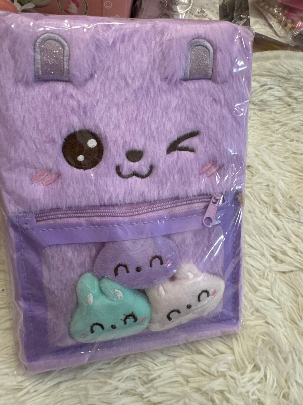 Purple fuzzy notebook cute cat face design and three plush cat faces inside
